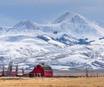 Photo of farm in front of mountains in Montana